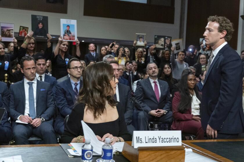 Meta CEO Mark Zuckerberg turns to address the audience during a Senate Judiciary Committee hearing on Capitol Hill in Washington, Wednesday, Jan. 31, 2024, to discuss child safety. X CEO Linda Yaccarino watches at left. (AP Photo/Jose Luis Magana)