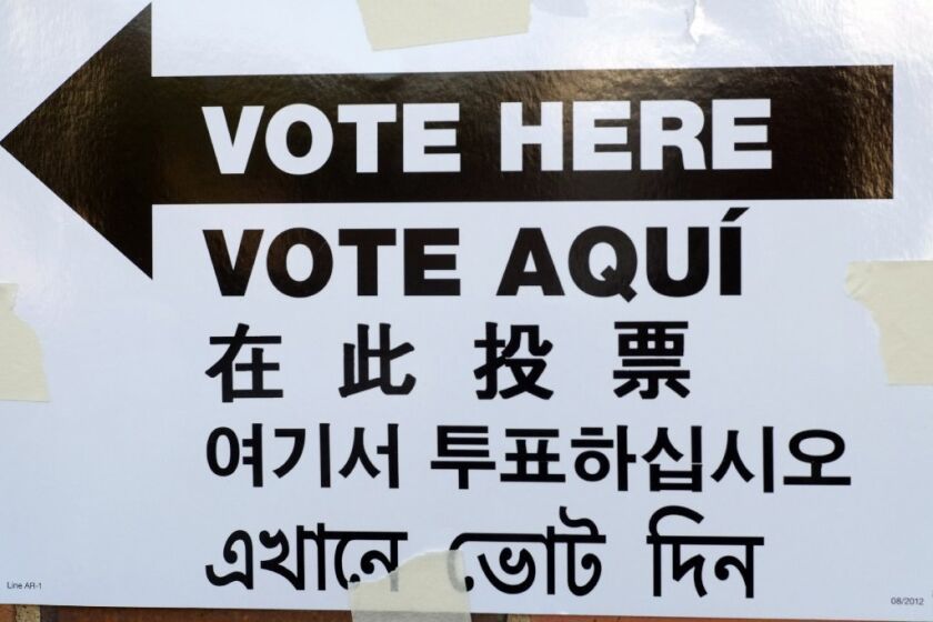 A sign is posted outside an election site in New York City that reads "Vote Here" in English, Spanish, Chinese, Korean and Bengali.