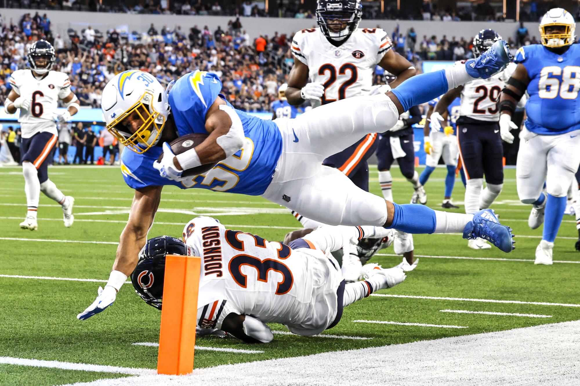 Los Angeles Chargers running back Austin Ekeler (30) dives over the end zone pylon to score a first quarter touchdown.