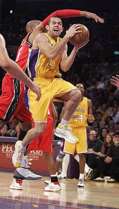 Lakers guard Jordan Farmar gets hit on the head by Vince Carter of the New Jersey Nets in the third quarter Tuesday night. Farmar scored 18 points and the Lakers defeated the Nets, 120-93.