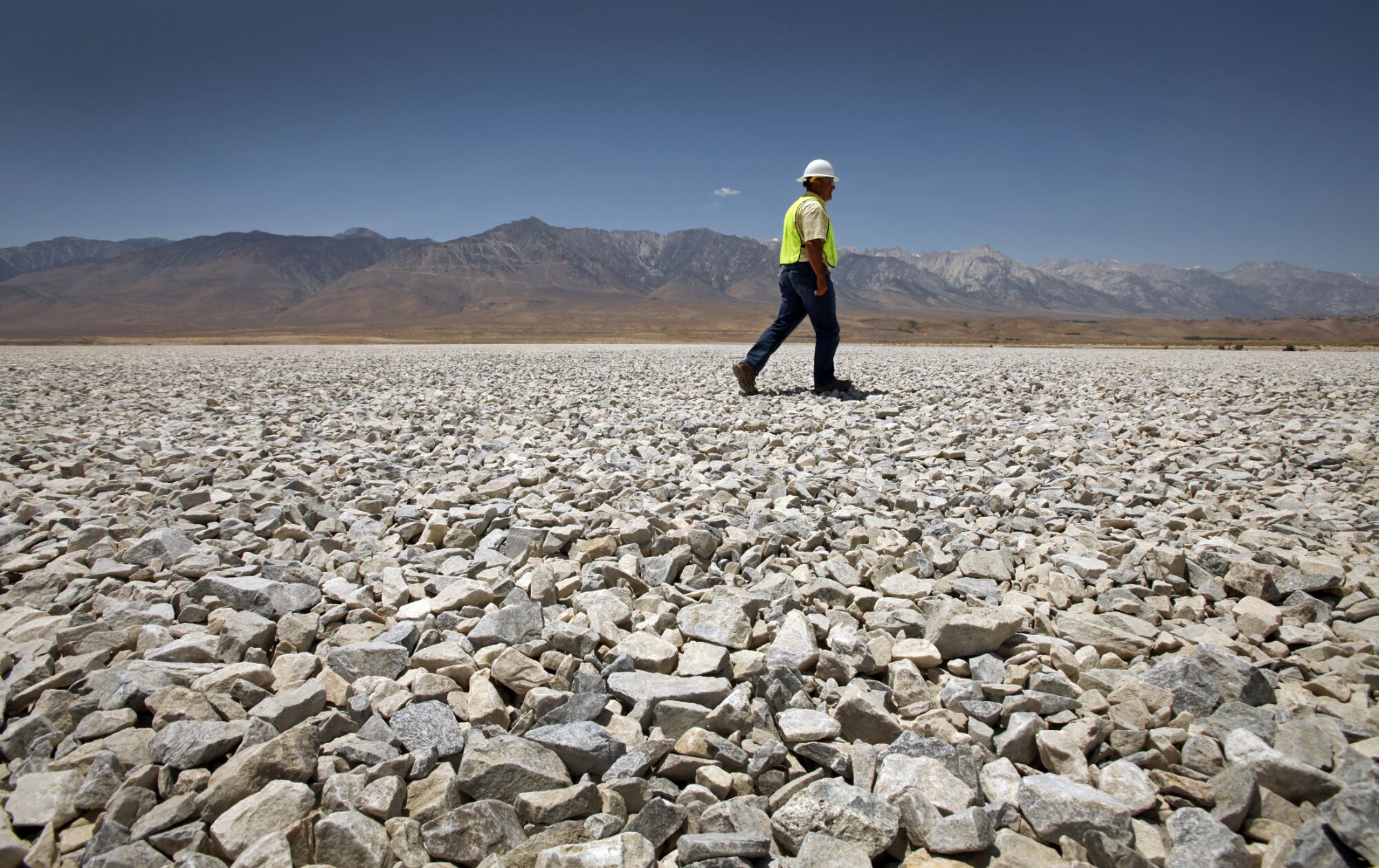 A DWP employee walks on the gravel project at Owens Lake in 2012.