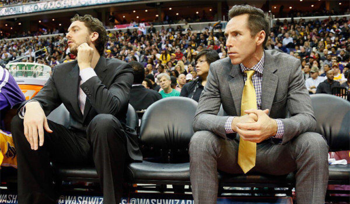 Pau Gasol and Steve Nash sit on the bench during the second half during the Lakers' win over the Washington Wizards, 102-96.