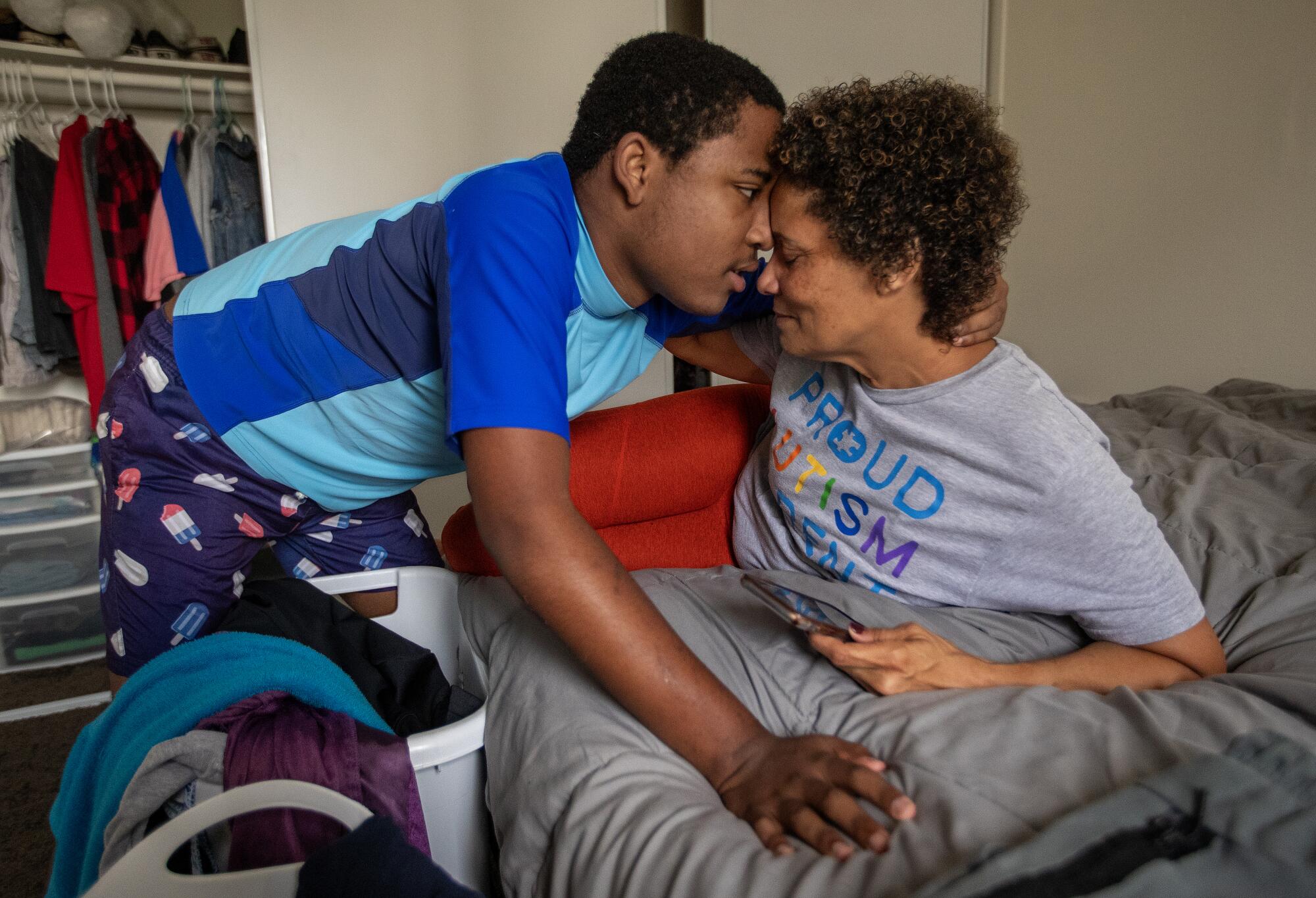 Noah, 14, embraces his mother Christine LyBurtus