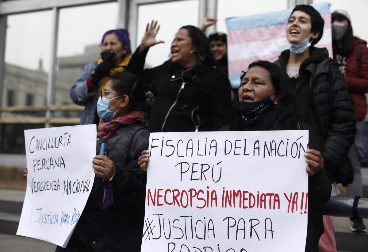Demonstrators protest to demand justice for Rodrigo Ventosilla, a Peruvian transgender man who died in Indonesia, outside the special prosecutor's office in Lima, Peru, Wednesday, Aug. 31, 2022. (AP Photo/Cesar Campos)