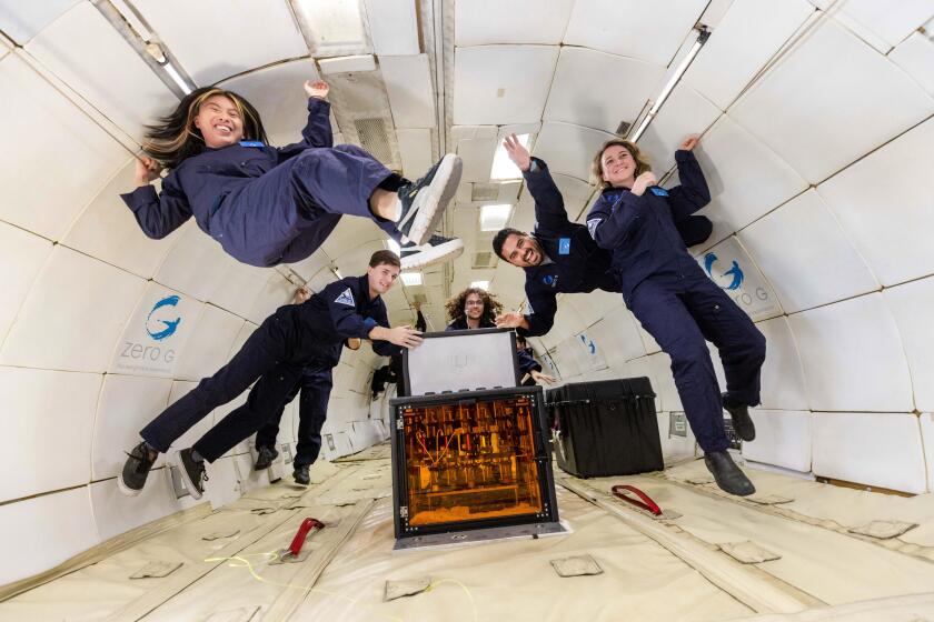BERKELEY, CALIFORNIA-Taylor Waddell, center, and other UC Berkeley researchers 3D printing in a zero gravity environment. Steve Boxall Photograhy
