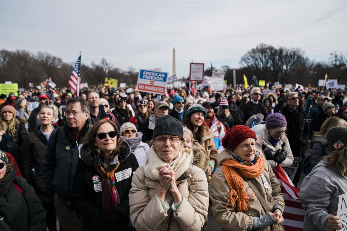People listen to speakers during a Defeat the Mandates Rally in Washington on Jan. 23. 