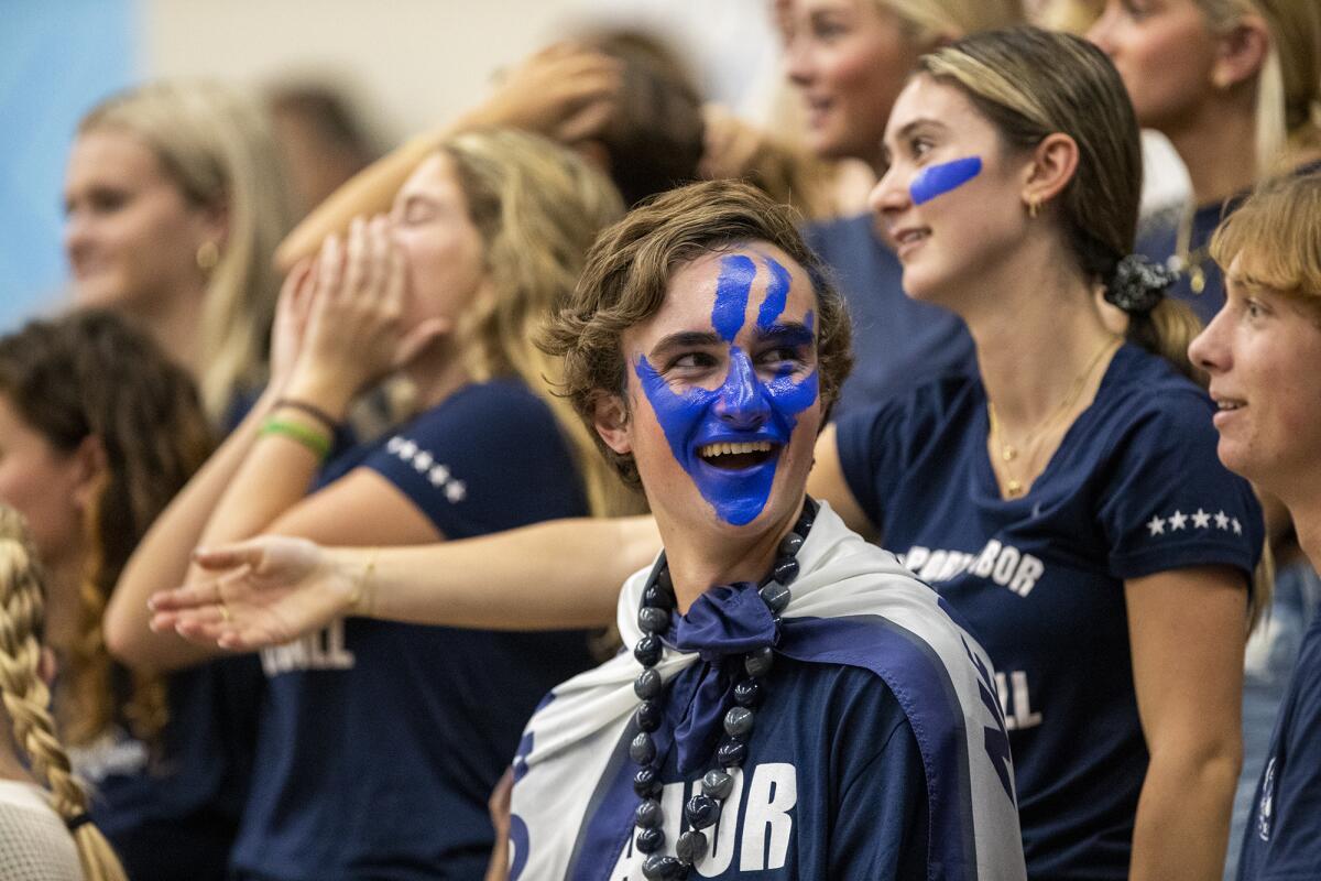 Newport Harbor fan Kyle McConaughey cheers during the Battle of the Bay girls' volleyball match on Wednesday.