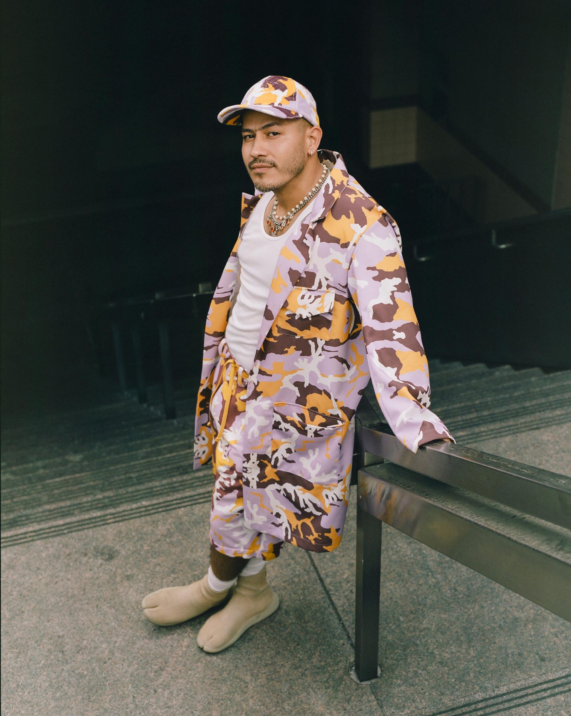 Rio Uribe, founder of Gypsy Sport poses in a camouflage outfit.