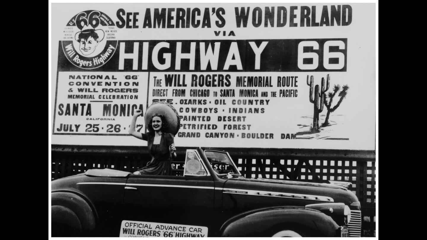 A billboard in 1940 touts the National "66" Convention & Will Rogers Memorial Celebration. The photo (printed circa 2010) is part of more than 250 historical artifacts on display at the Autry museum.