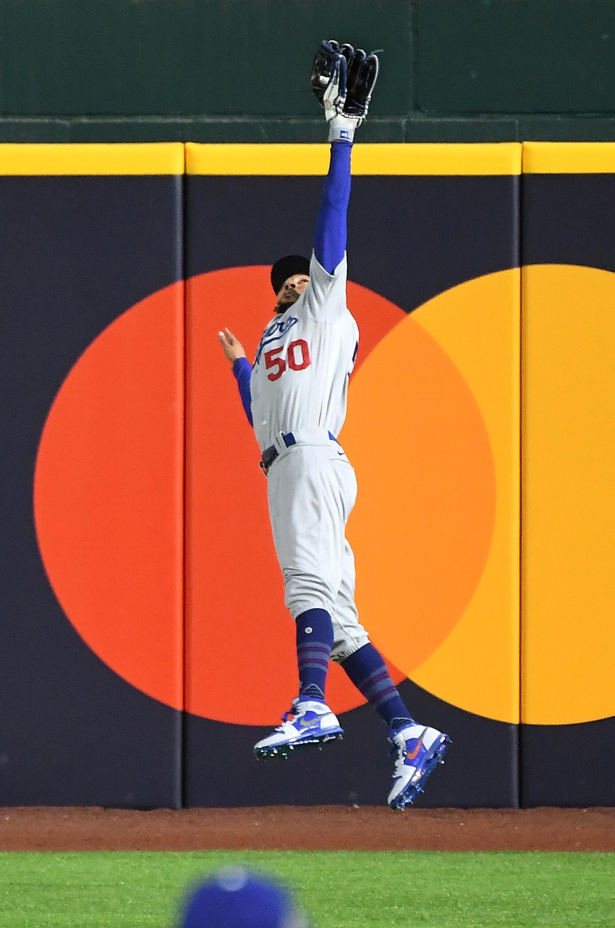 Dodgers right fielder Mookie Betts makes a leaping catch off the bat of Brandon Lowe in the second inning.