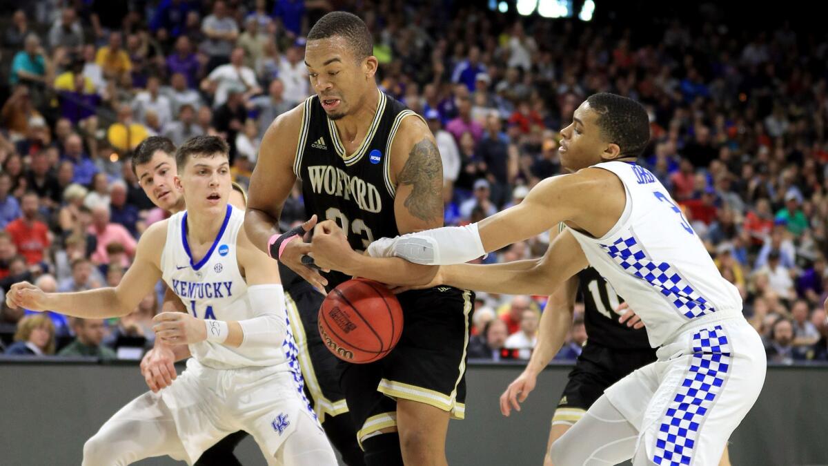 Wofford's Cameron Jackson (33) fights for the ball against Kentucky's Tyler Herro (14) and Keldon Johnson (3) during the second half of the second round of the NCAA tournament on Saturday in Jacksonville, Fla.