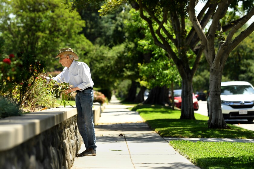 Pasadena, California April 15 2022- A resident pulls weeds near a house that sold for $2.5 million in cash after being listed for 1.2 million on Stratford Ave. in South Pasadena. (Wally Skalij/Los Angeles Times)