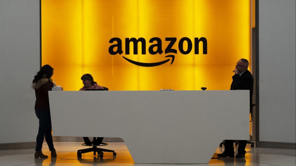 People stand in the lobby of the Amazon office in New York City on Feb. 14.