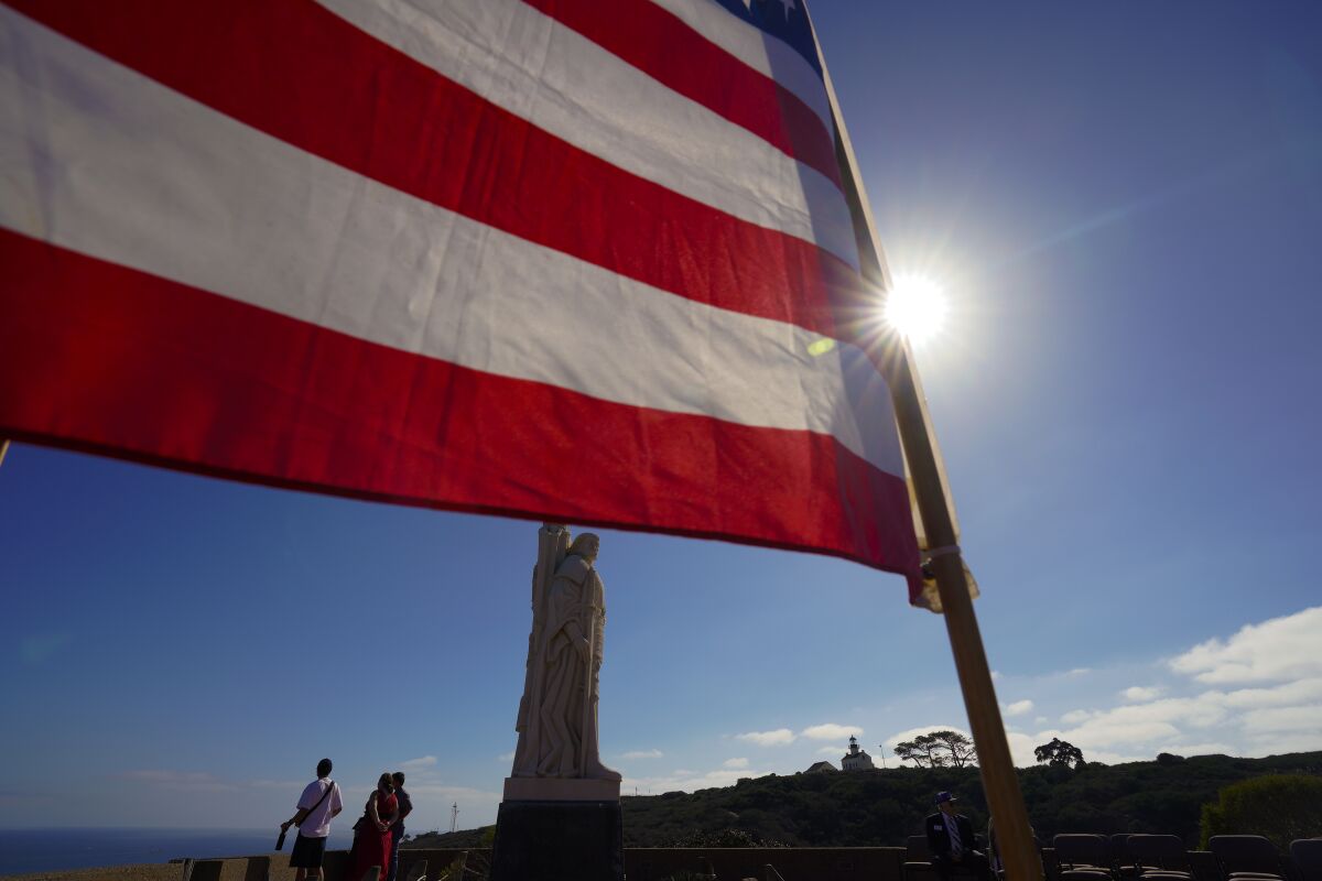 An American flag frames the statue of Juan Rodríguez Cabrillo at the Cabrillo National Monument.
