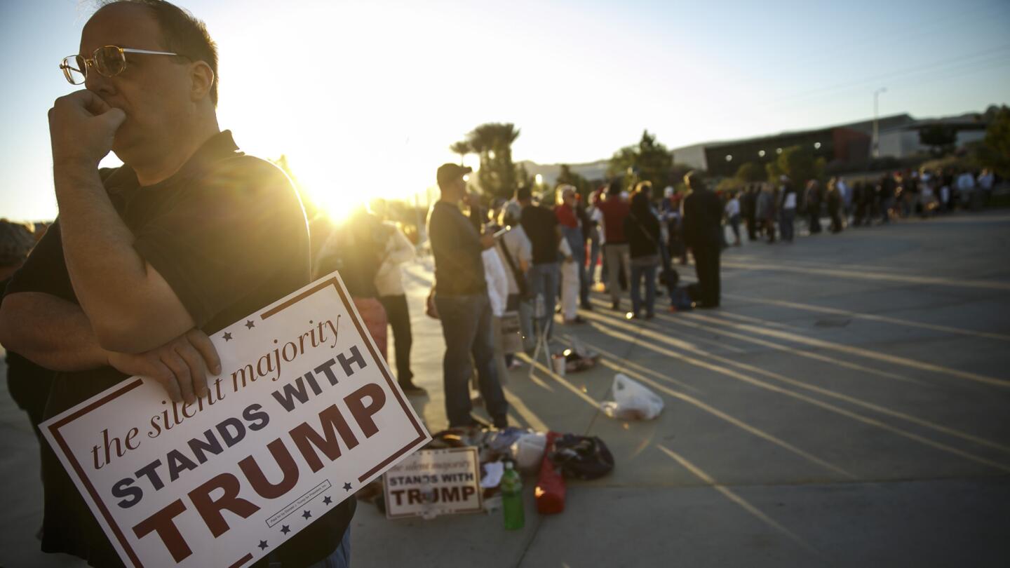 A Donald Trump supporter waits in line to enter an ampitheater in Henderson, Nev., for a campaign rally on Wednesday.