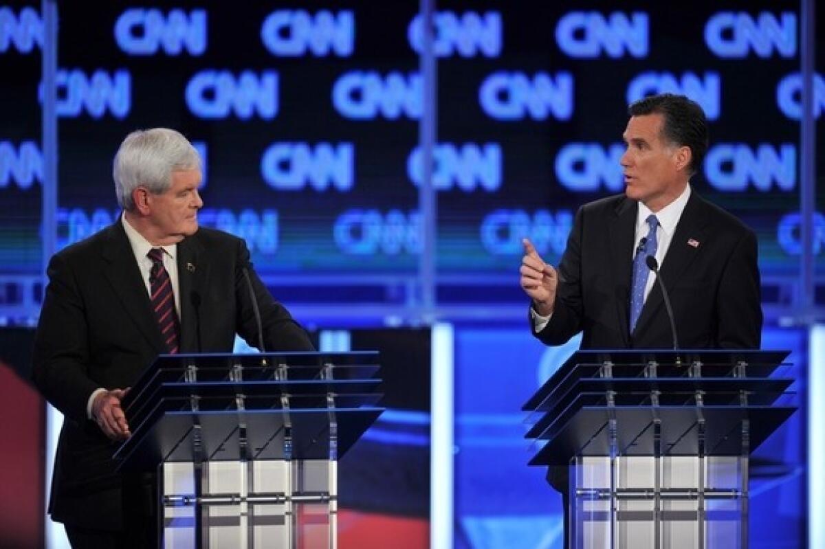Newt Gingrich listens to Mitt Romney during the Florida Republican presidential debate Jan. 26, 2012 at the University of North Florida in Jacksonville, Fla.