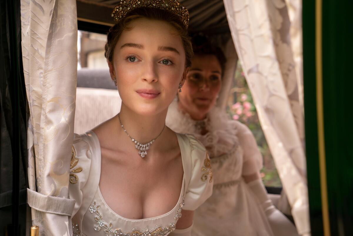Phoebe Dynevor and Ruth Gemmell in a carriage in "Bridgerton."