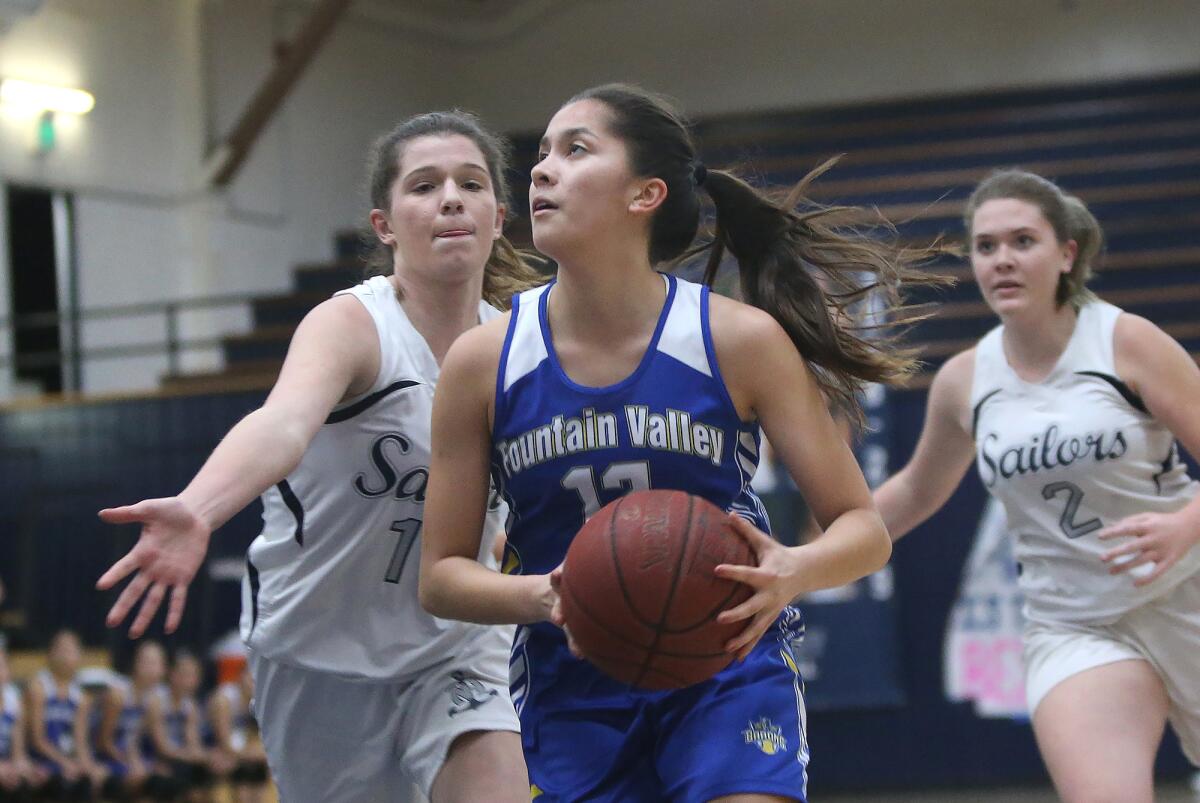 Fountain Valley's Margaret Tengan, pictured driving against Newport Harbor on Jan. 24, led the Barons to Thursday's 62-17 win over Katella.