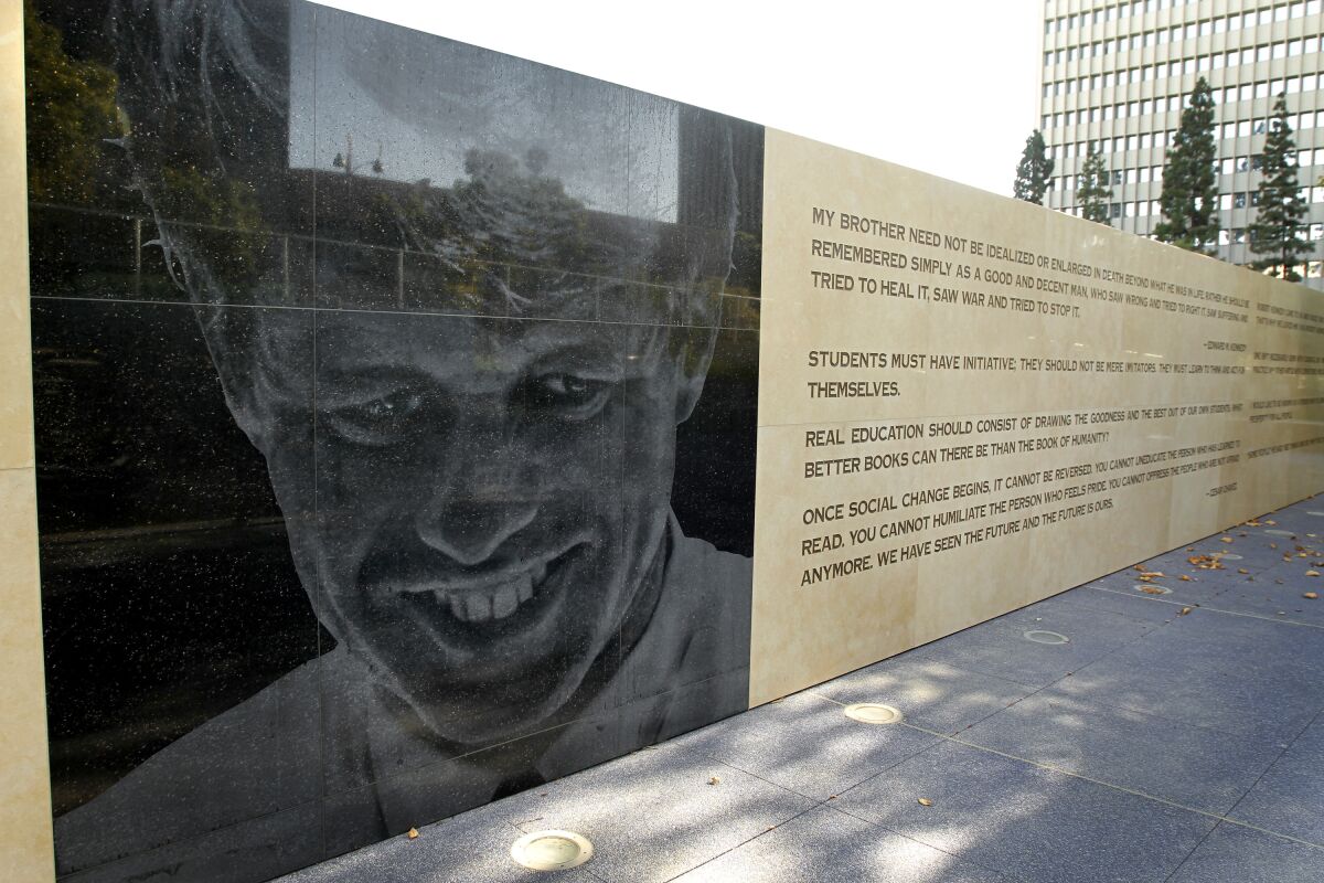 Image of Robert F. Kennedy on a wall outside next to a quote on the wall. 