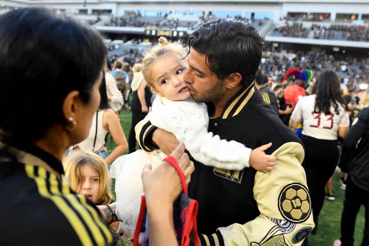 LAFC's Carlos Vela celebrates with his family after a victory over the Philadelphia Union to win the MLS Cup on Nov. 5, 2022.