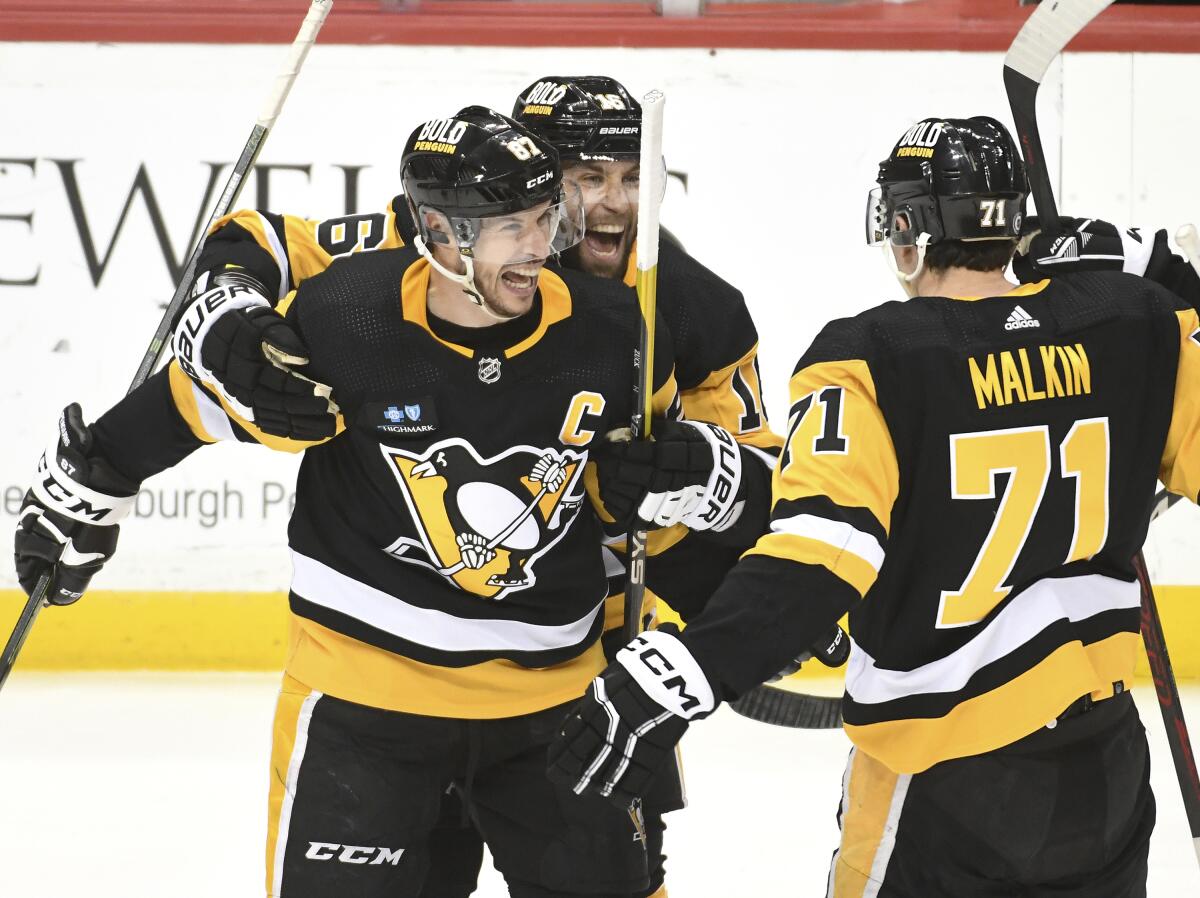 Pittsburgh Penguins' Rickard Rakell, left, celebrates his goal