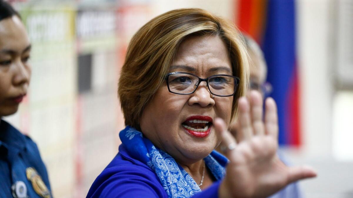 Philippine Sen. Leila De Lima gestures after arriving at a metropolitan trial court for her arraignment in Quezon City, east of Manila, on March 13, 2017.