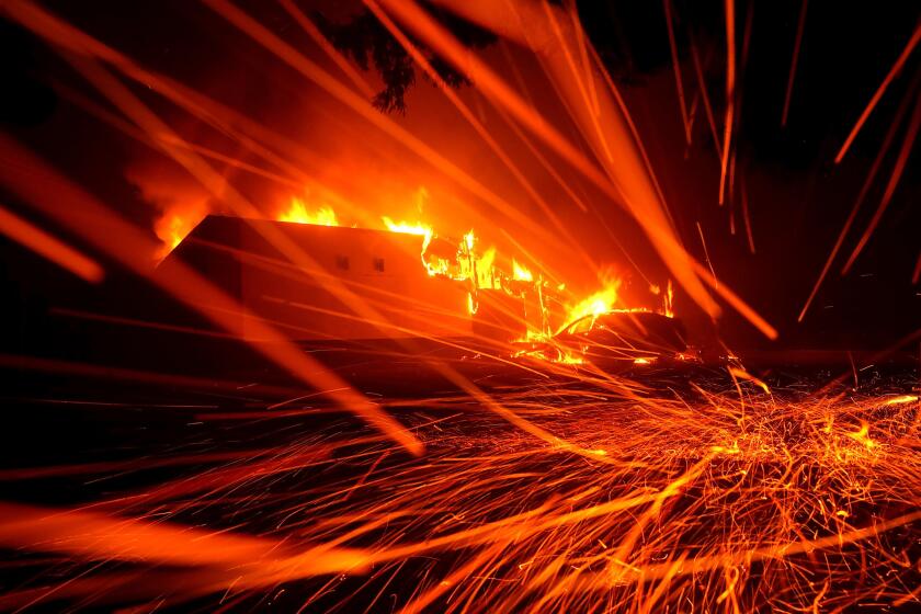 PARADISE, CA - NOVEMBER 08: Embers blow in the wind as a Camp Fire burns a KFC restaurant on November 8, 2018 in Paradise, California. Fueled by high winds and low humidity, the rapidly spreading wildfire has ripped through the town of Paradise, charring 18,000 acres and destroying dozens of homes in a matter of hours. The fire is currently at zero containment. (Photo by Justin Sullivan/Getty Images)