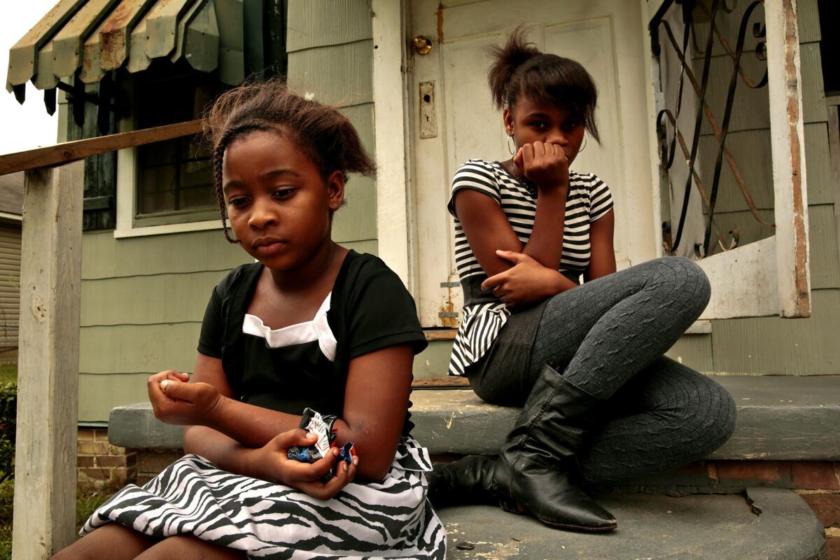 Ceaira Revish, 9, left, and Bobbie Parker, 13, live in the Mid-City neighborhood. Bobbie says she had lead poisoning as a young child and spent months in a hospital. Working parents in Louisiana get publicly funded medical care only if they make less than a quarter of the federal poverty level, or $4,687 for a family of three. By contrast, Minnesota will make fully subsidized coverage available this year to families of three making up to $26,951.