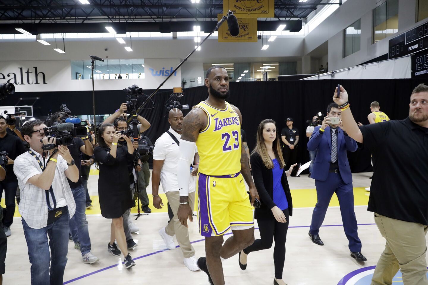 Members of the media follow Los Angeles Lakers' LeBron James (23) during media day at the NBA basketball team's practice facility Monday, Sept. 24, 2018, in El Segundo, Calif. (AP Photo/Marcio Jose Sanchez)