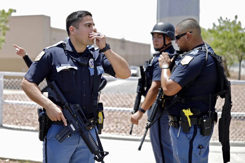 Mandatory Credit: Photo by IVAN PIERRE AGUIRRE/EPA-EFE/REX (10353526b) Police stand at attention during an active shooting at a Walmart in El Paso, Texas, USA, 03 August 2019. According to reports, at least one person was killed and at least 18 people injured and transported to local hospitals. One suspect is in custody. Shooting at Walmart in El Paso, Texas, USA - 03 Aug 2019 ** Usable by LA, CT and MoD ONLY **