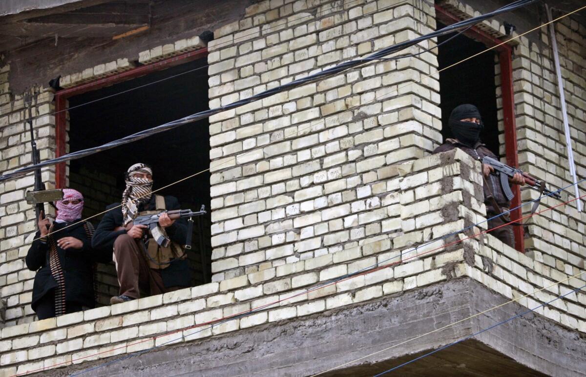 Masked Sunni gunmen are seen taking position in Fallujah, Iraq.