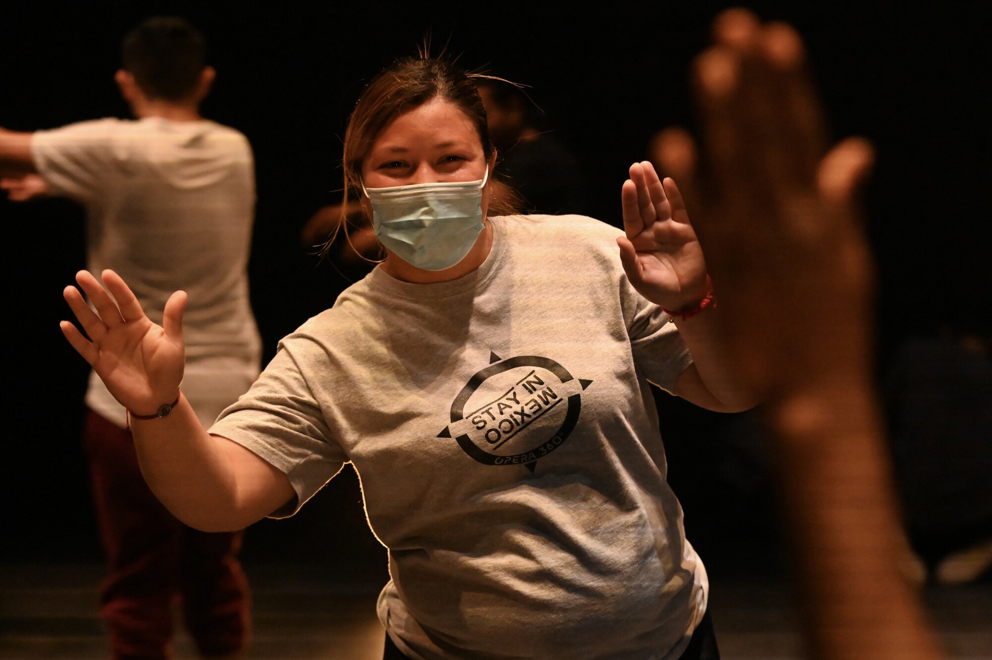 Migrants during a practice dance rehearsal for the "Stay in Mexico" Opera 360 