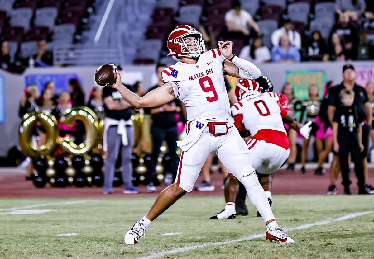 Quarterback Dash Beierly of Mater Dei reaches back to make a deep throw from the pocket.