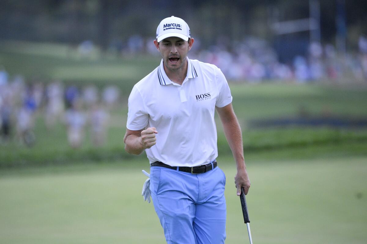 Patrick Cantlay reacts after sinking in his putt on the 18th green, the sixth playoff hole.