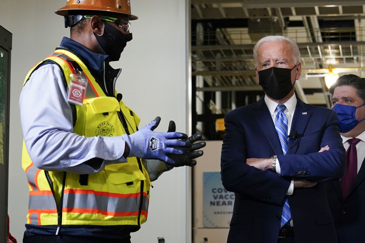 President Biden listens on a tour of a Microsoft data center.