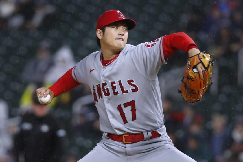 Los Angeles Angels starting pitcher Shohei Ohtani throws to a Minnesota Twins batter.