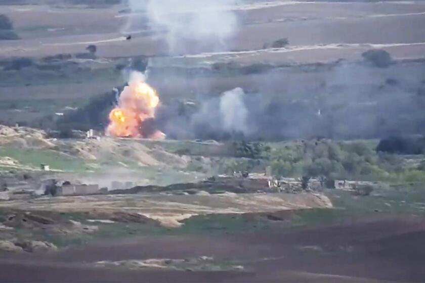 This image taken from a video released by Armenian Defense Ministry on Monday, Sept. 28, 2020 allegedly shows fighting between Armenian and Azerbaijani forces at the contact line of the self-proclaimed Republic of Nagorno-Karabakh, Azerbaijan. Armenian and Azerbaijani forces fought over the separatist region of Nagorno-Karabakh for a second day Monday, with both sides blaming each other for resuming the attacks that reportedly killed and wounded dozens as the decades-old conflict has reignited.(Armenian Defense Ministry via AP)