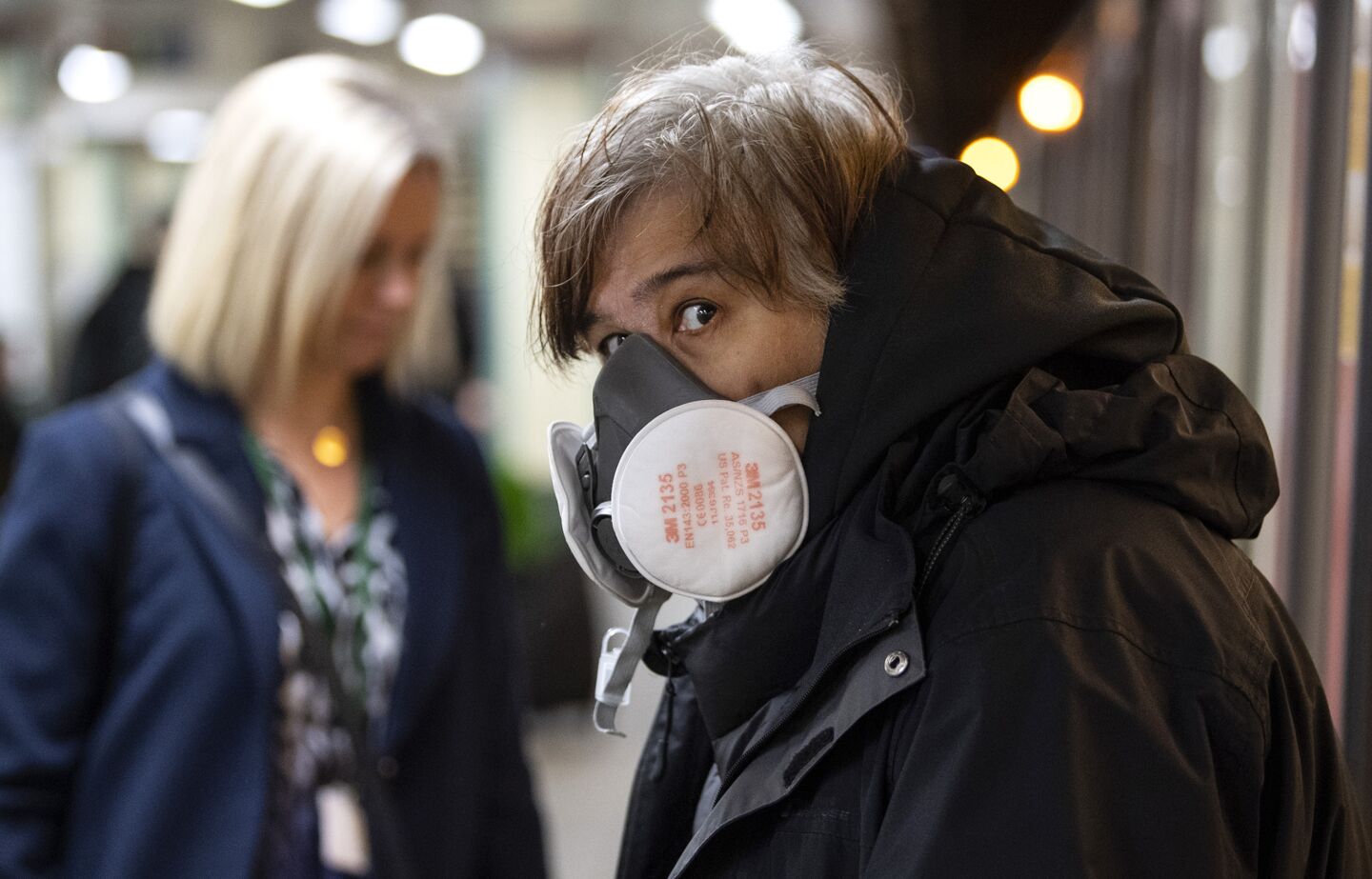 Britain: A commuter wearing a face protection mask travels on the Underground tubes.