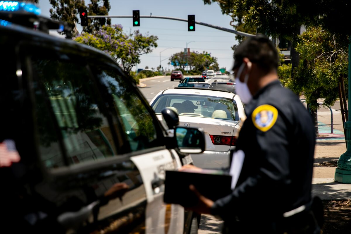 San Diego police officers make a traffic stop along El Cajon Boulevard on June 23, 2020.