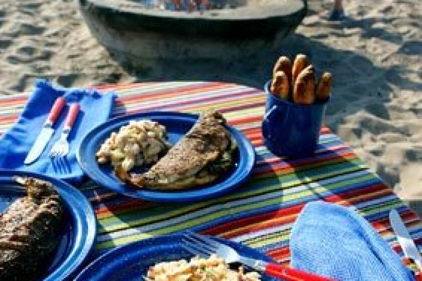 Whatever the activity, or lack thereof, a fabulous dinner is a great way to cap off a day outdoors. All that's needed is a campfire, a little planning, a skillet and a Dutch oven. Here, at Dockweiler State Beach, a camp menu includes pan-fried trout, white bean salad and buttermilk stick biscuits.
