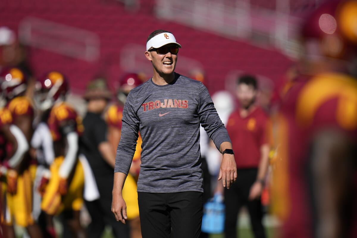 USC coach Lincoln Riley talks to his players as they warm up before a win over San José State on Aug. 26.