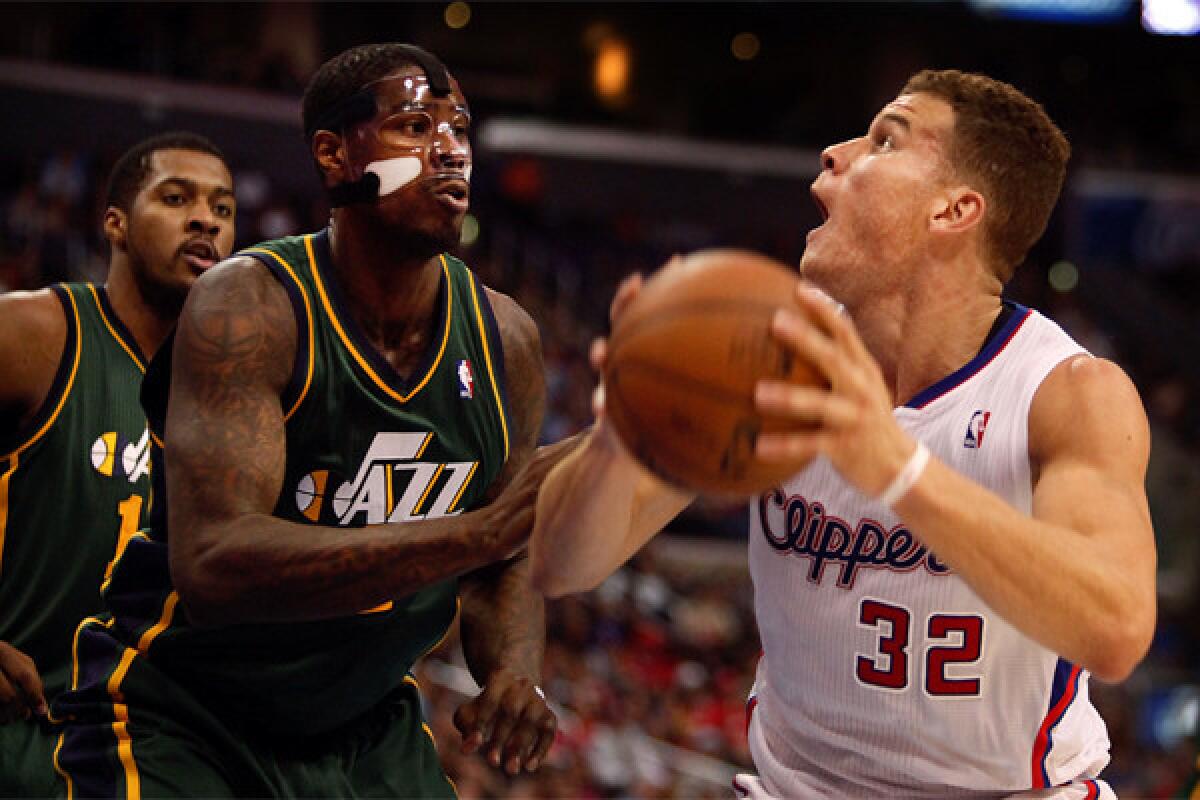 Blake Griffin takes aim against Utah's Marvin Williams on Saturday night at Staples Center.