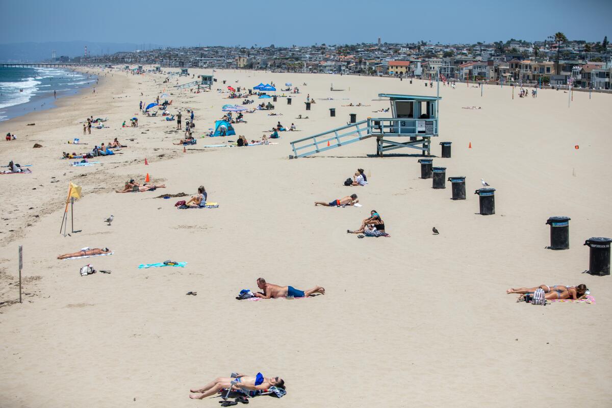 HERMOSA BEACH, CA - JULY 02: People work to be socially distant on the sand of Hermosa Beach, CA, on Thursday, July 2, 2020, the day before Los Angeles County beaches close for the July 4th holiday, under order from California Gov. Gavin Newsom, in an effort to slow the spread of the coronavirus. (Jay L. Clendenin / Los Angeles Times)