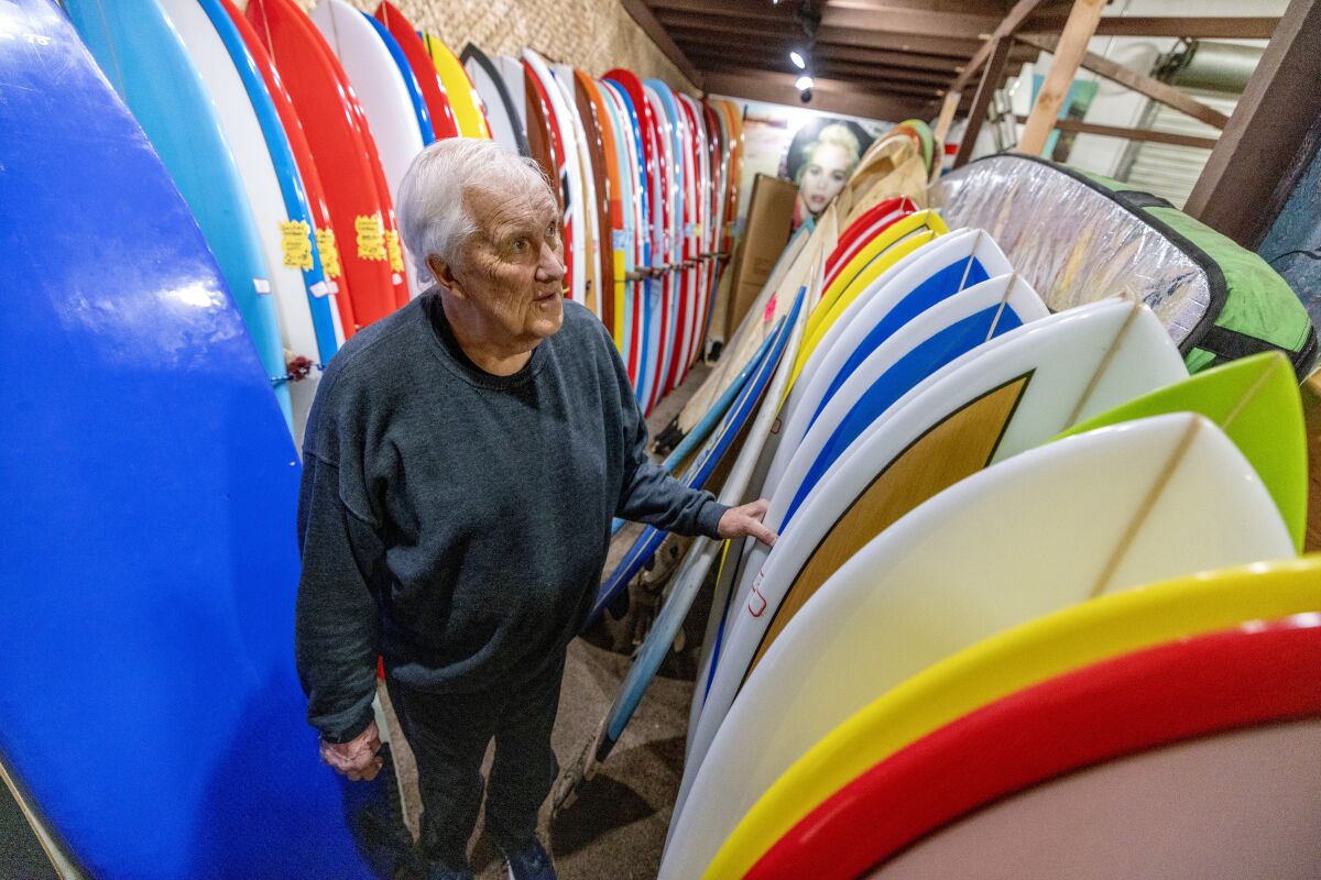 Cardiff resident John Gundersen, 77, among his surfboards at his business, Woody Resin Surf Products in Oceanside.