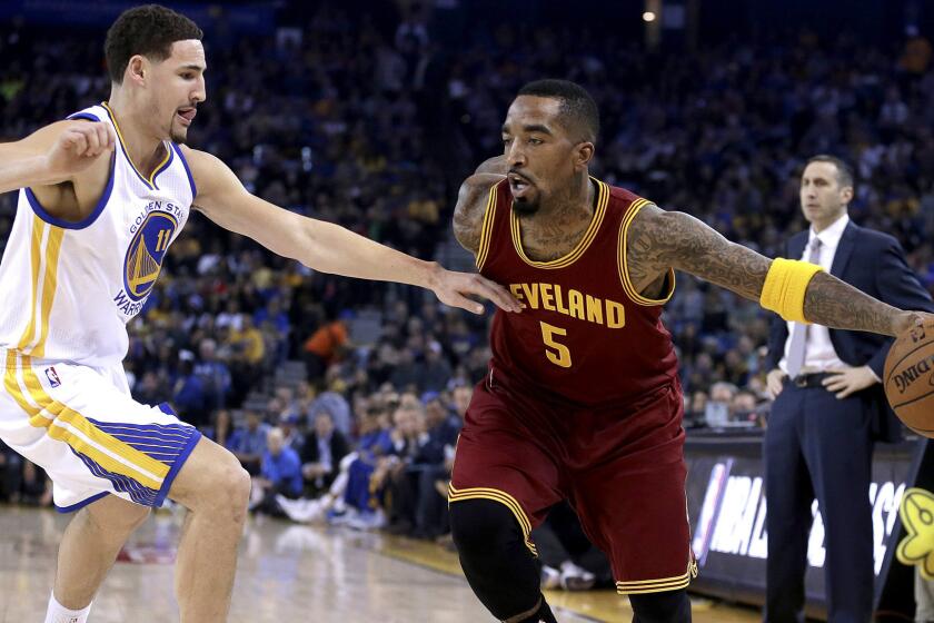 Cavaliers guard J.R. Smith looks to drive the baseline against Warriors guard Klay Thompson during a game Jan. 9 in Oakland.