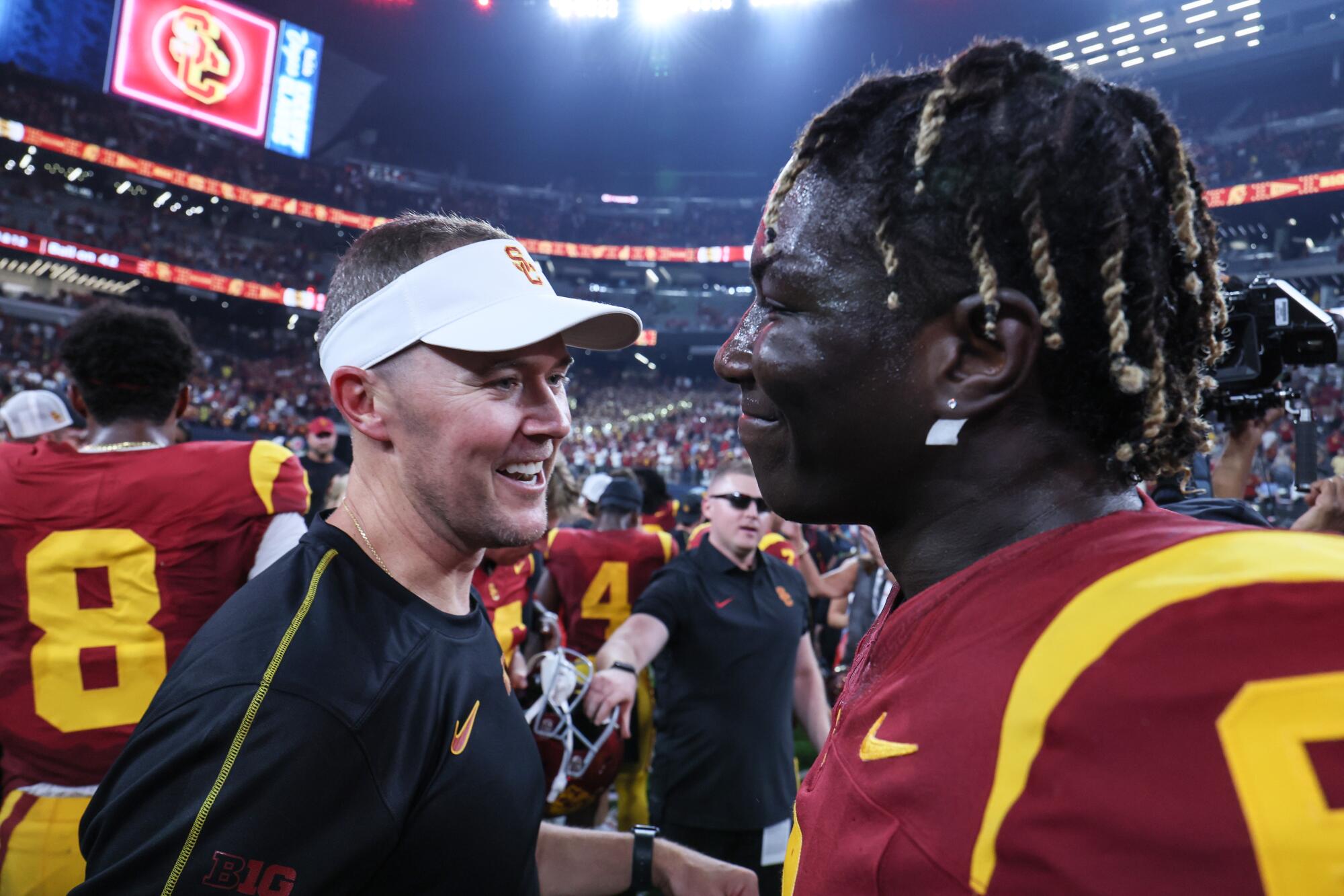 USC coach Lincoln Riley celebrates with defensive end Anthony Lucas after a 27-20 victory over LSU.