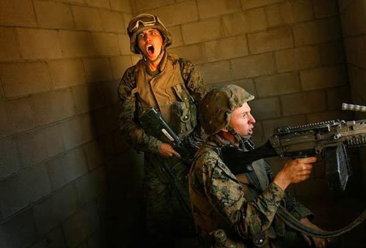Marine Lance Cpls. Daryl Crookston and Steven Dellinger come under mock attack during School of Infantry training at Camp Pendleton.