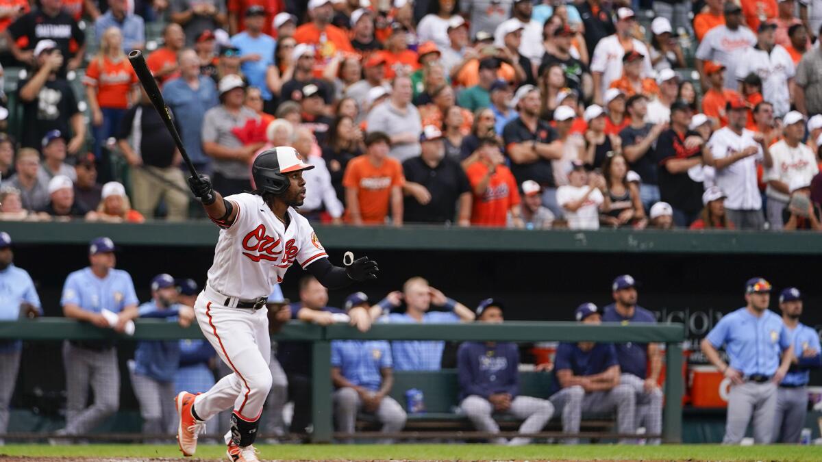 Baltimore Orioles second baseman Adam Frazier (12) safely reaches third  base after a wild pitch was thrown in the bottom of the second inning  against the Tampa Bay Rays at Oriole Park