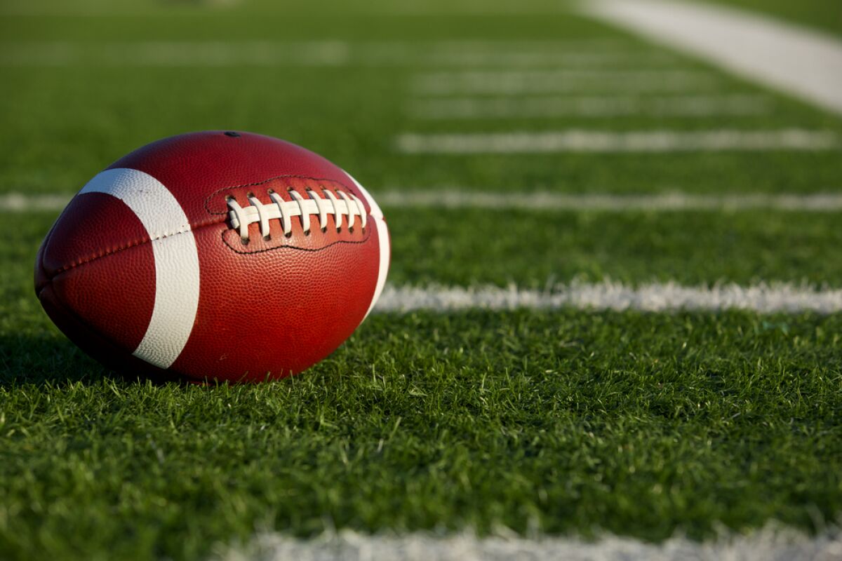 A closeup of a football on a football field