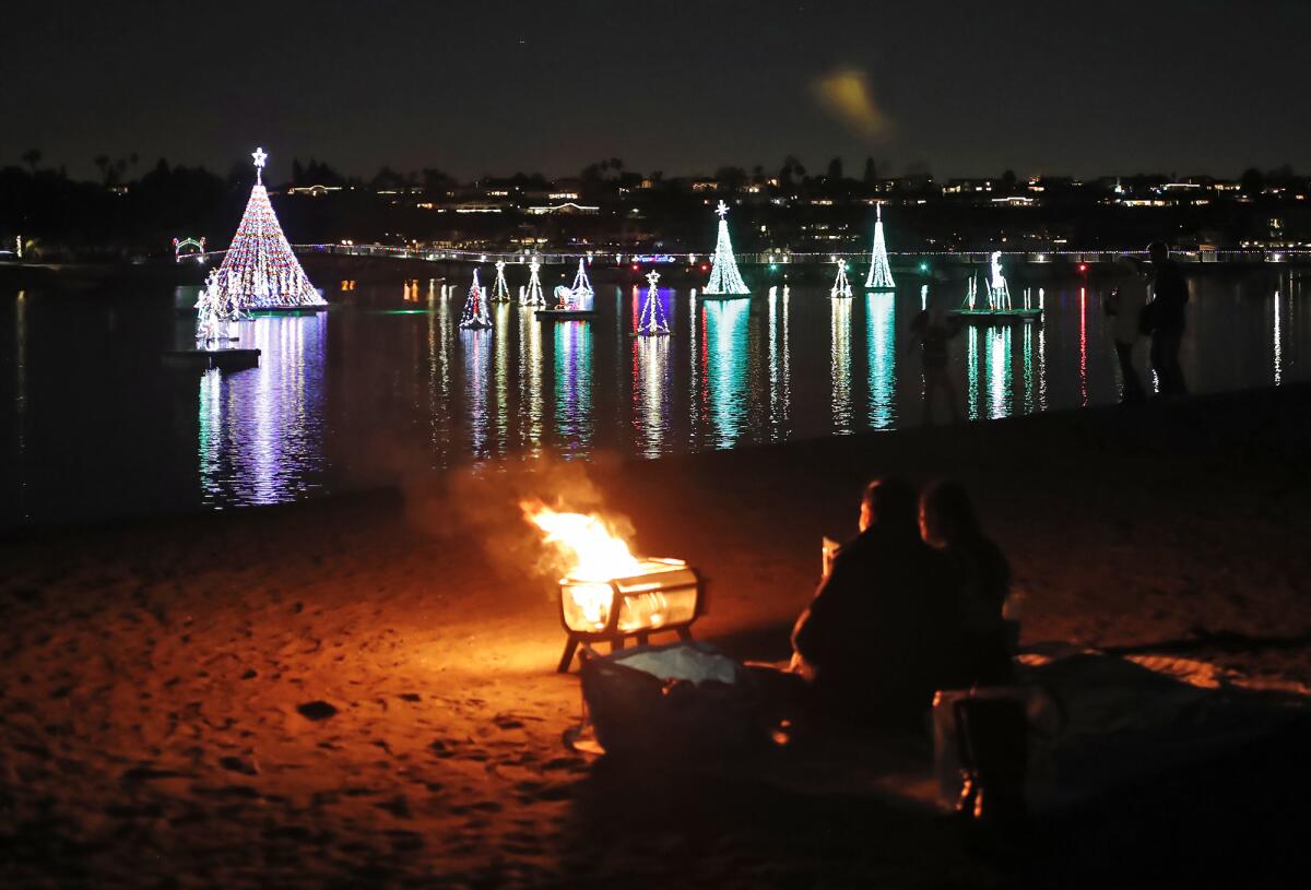 A couple manages one small campfire at the Newport Dunes Waterfront Resort & Marina.